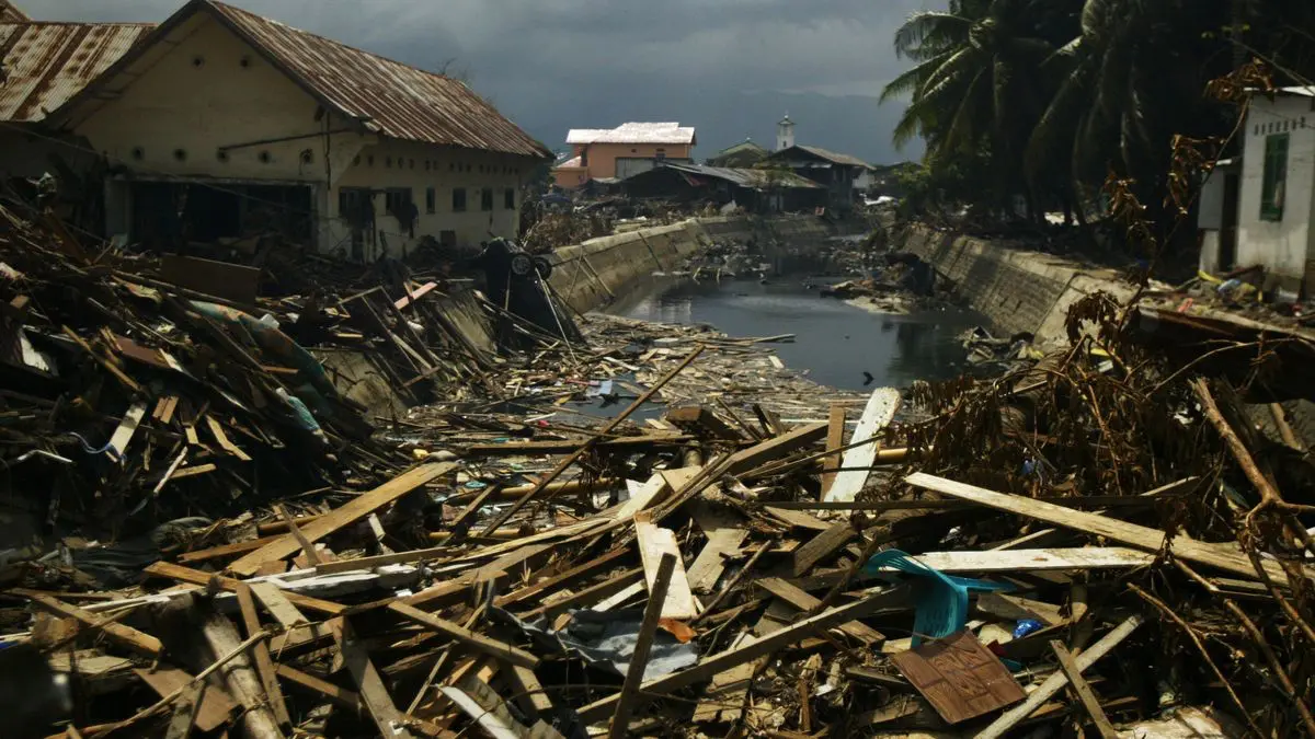 Trosky domů a zničené ulice po obrovské tsunami v roce 2004. Všude dřevo, bahno a ticho, které zůstalo po síle oceánu.