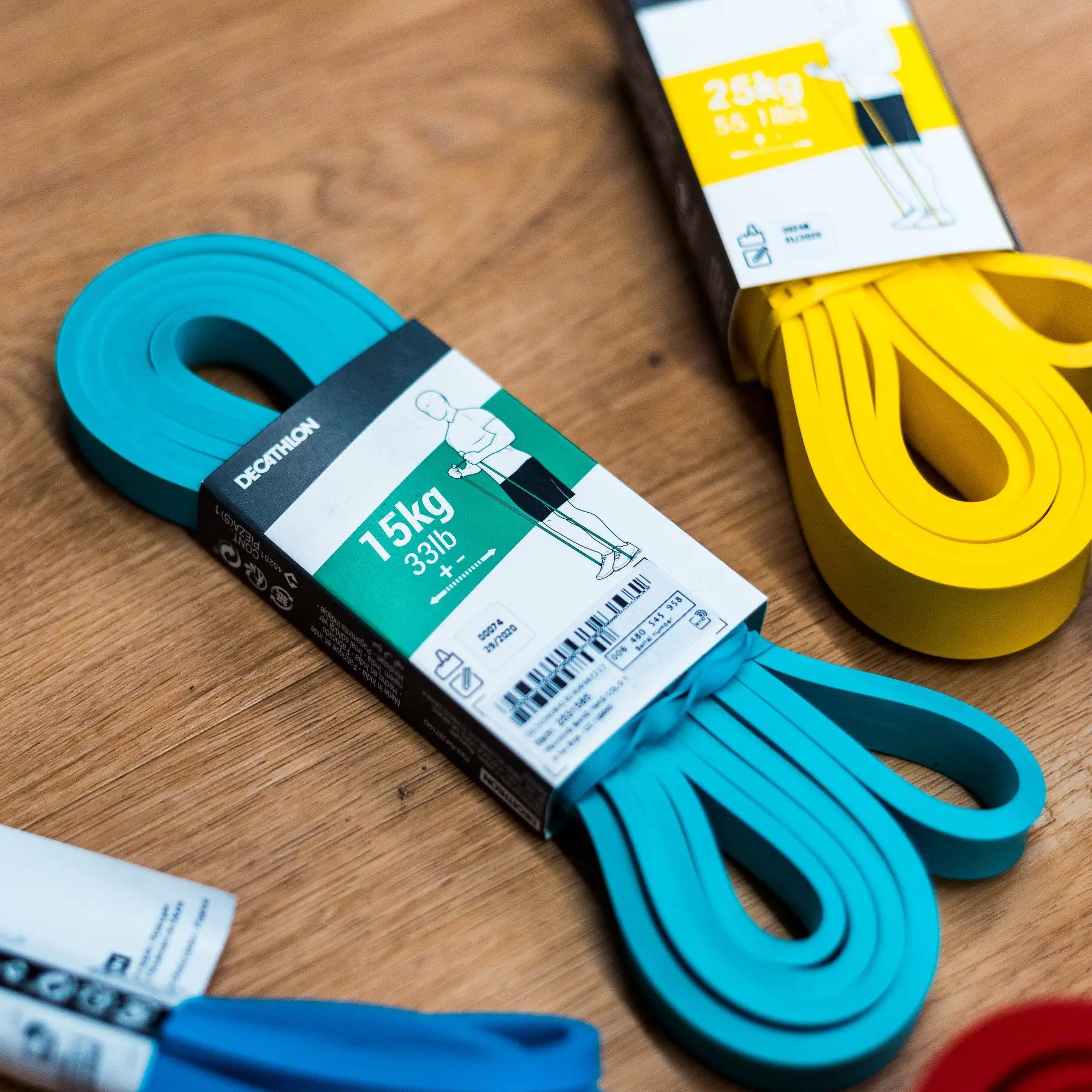 Barevné odporové gumy DOMYOS z Decathlonu pro domácí trénink.