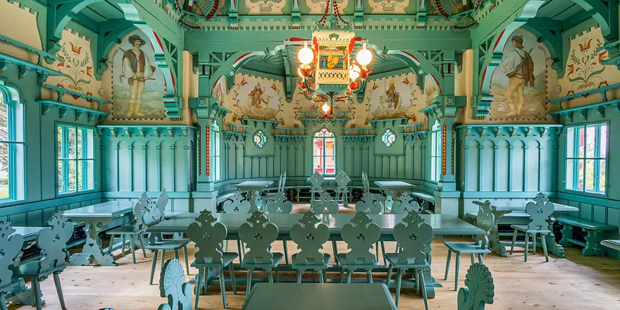 Jurkovic pustevny | Venclíkovi.cz Secesní interiér chaty Maměnka v modrozelené barvě s folklorními malbami